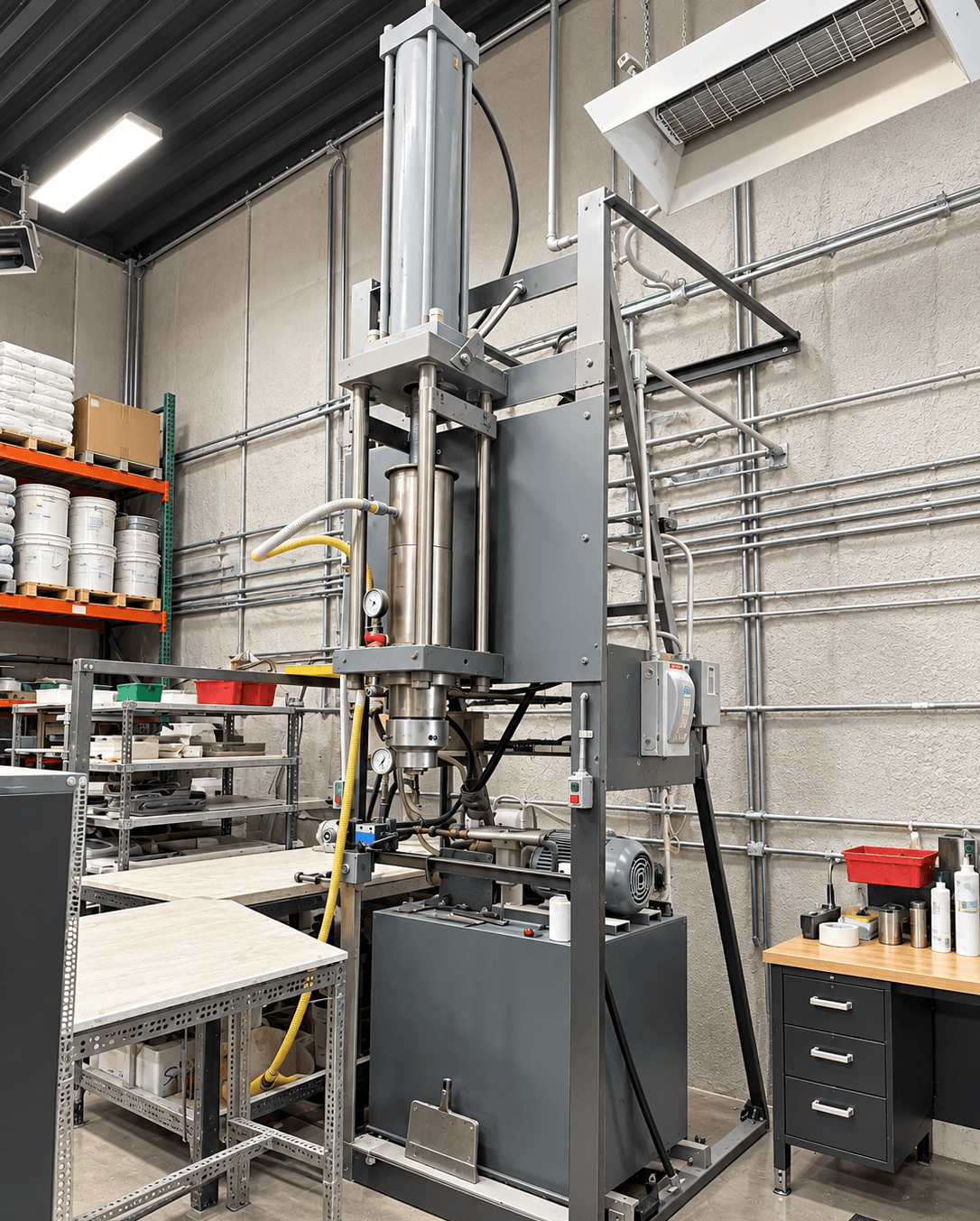 A vertical piston extruder on the Associated Ceramics production floor.
